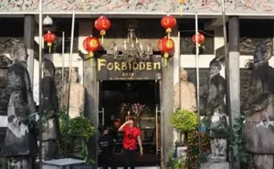 A woman outside forbidden city in Singapore - CryptoLists.com Singapore, Forbidden city